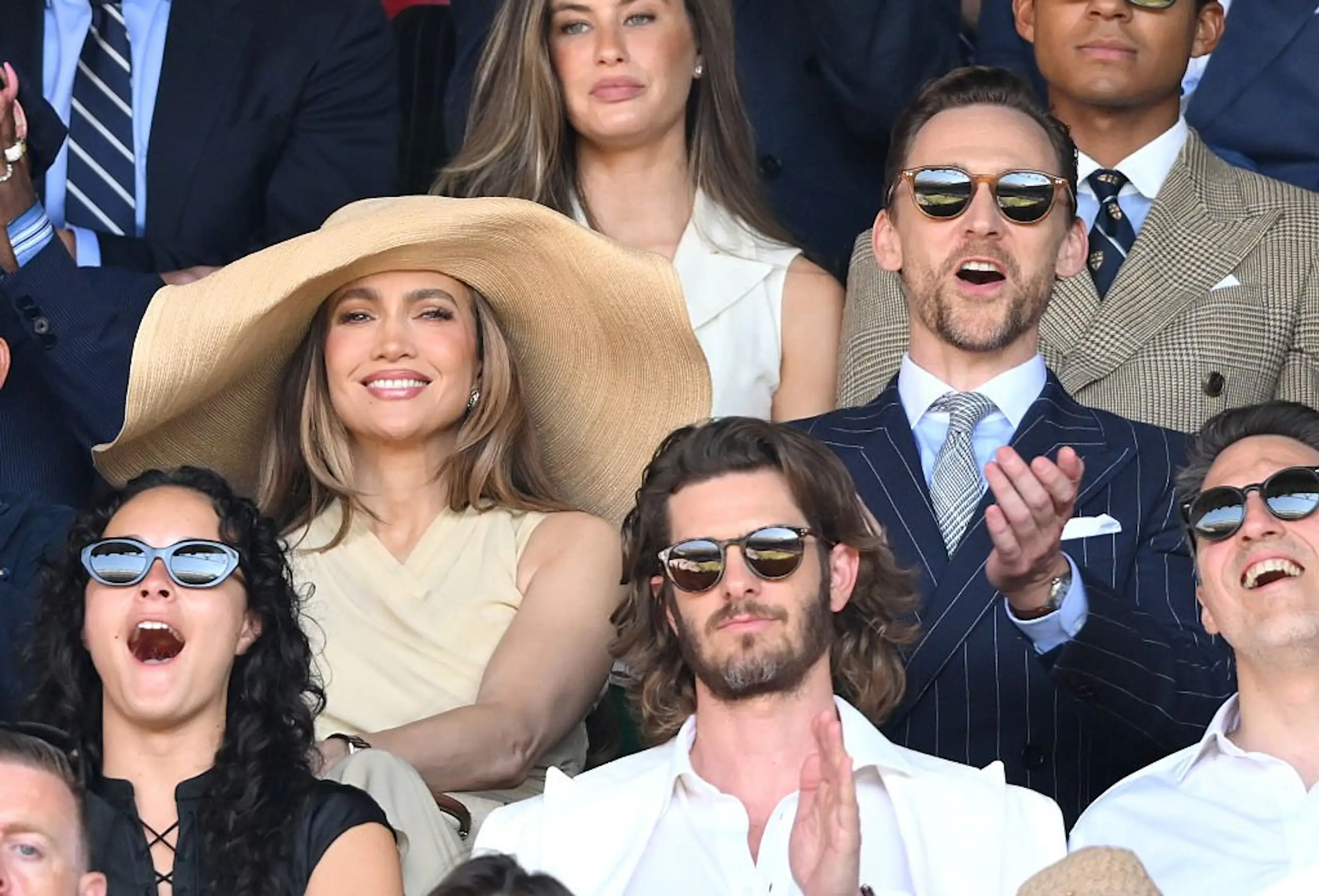 Jennifer Lopez sat next to Tom Hiddleston in a huge hat. Credit: Karwai Tang/WireImage/Getty Images