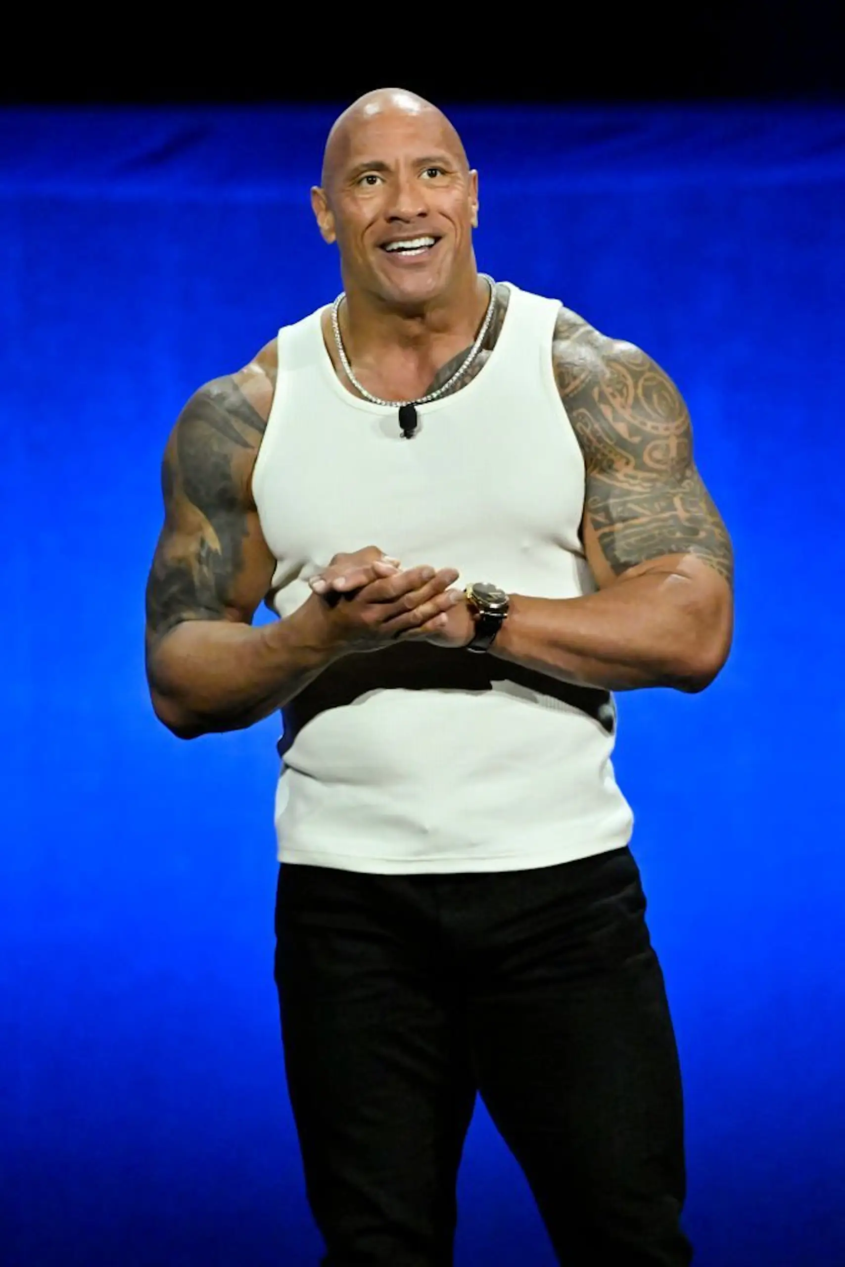 This is the real photo of Dwayne Johnson speaking at the Walt Disney Studios Presentation during CinemaCon 2024. Credit: David Becker / Getty
